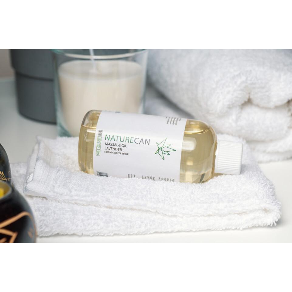 CBD massage oil bottle shown on a towel